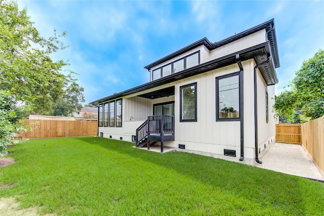 back of house featuring a yard