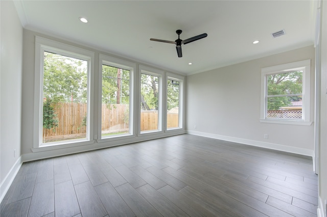 unfurnished room featuring ceiling fan, plenty of natural light, and dark hardwood / wood-style floors