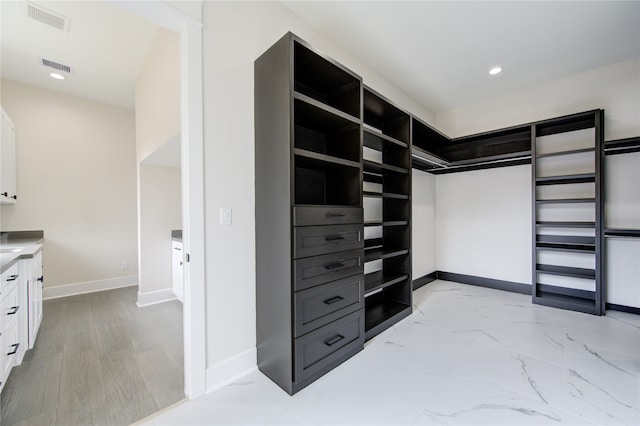 spacious closet featuring light hardwood / wood-style floors