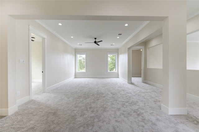 unfurnished living room with crown molding, light colored carpet, and ceiling fan