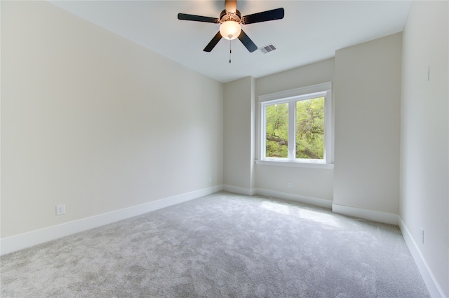 carpeted empty room featuring ceiling fan