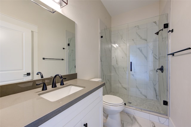 bathroom featuring vanity, toilet, and a shower with shower door