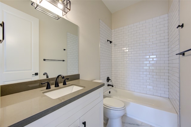 full bathroom with vanity, toilet, and tiled shower / bath