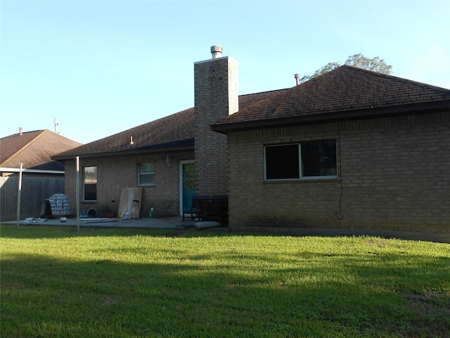 rear view of property with a patio area and a yard