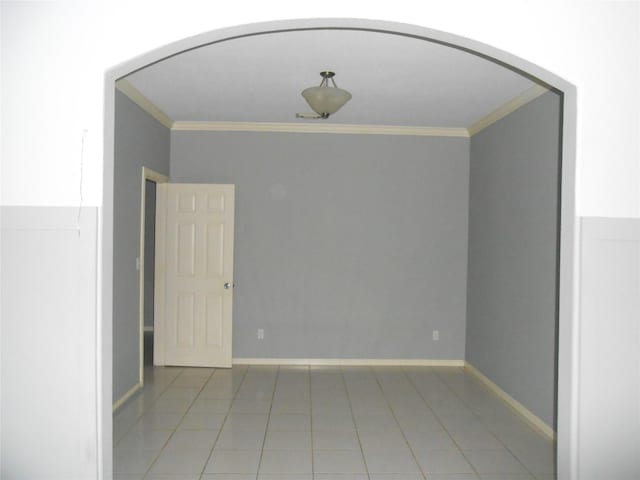 unfurnished room featuring tile patterned flooring and ornamental molding