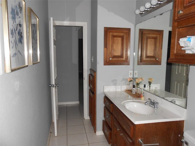 bathroom featuring tile patterned flooring, vanity, and toilet