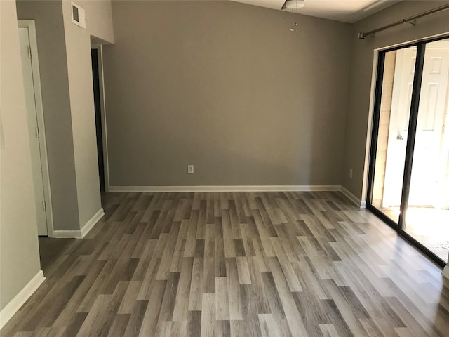 spare room featuring dark hardwood / wood-style flooring