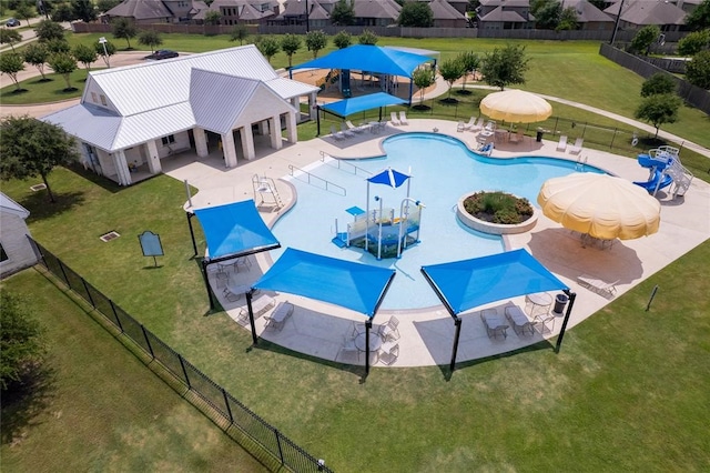 view of pool with a lawn and a patio