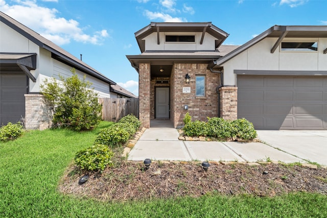 view of front of property featuring a garage and a front yard