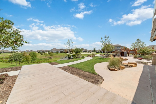 view of property's community with a lawn