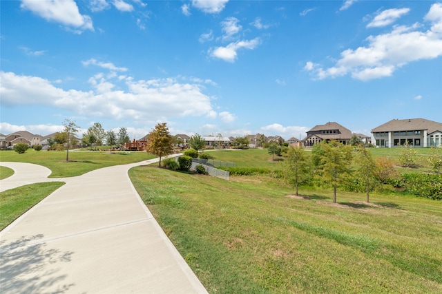 view of property's community with a lawn