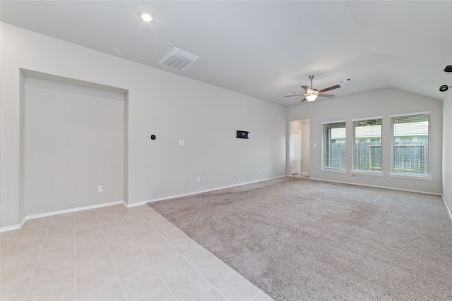 carpeted empty room featuring ceiling fan and vaulted ceiling