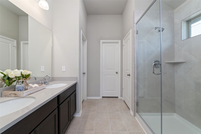 bathroom with a shower with shower door, tile patterned flooring, and vanity