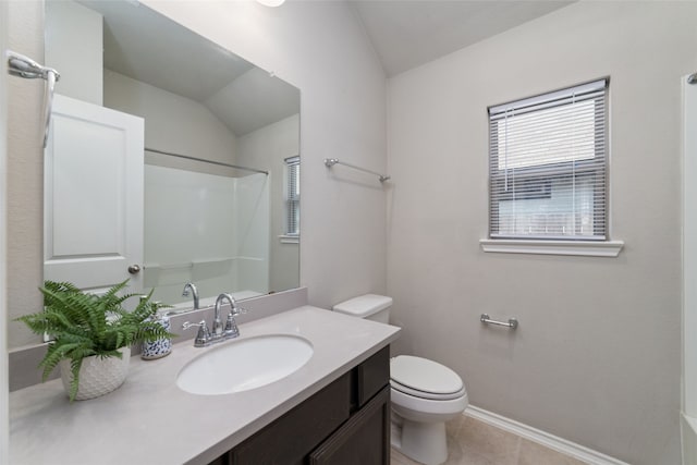 bathroom with tile patterned floors, vaulted ceiling, toilet, and vanity