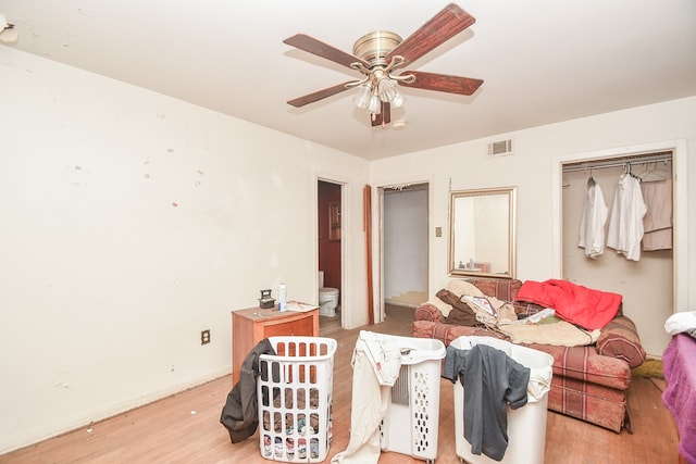 living room featuring ceiling fan and light hardwood / wood-style floors