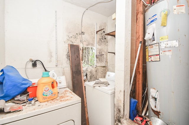 clothes washing area with washing machine and dryer and gas water heater