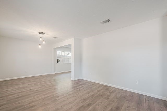 unfurnished room with wood-type flooring