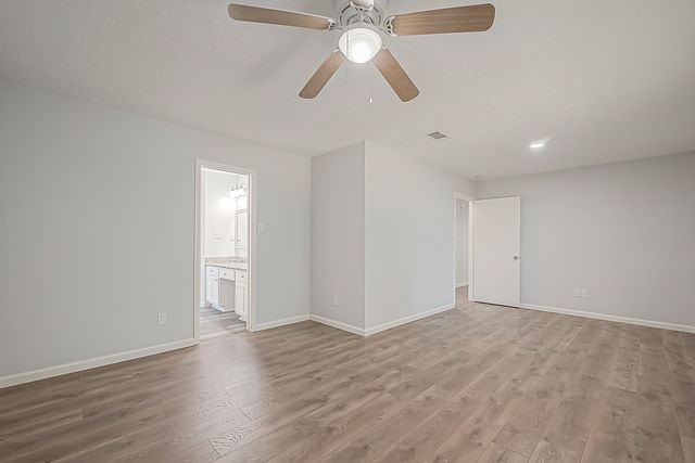 empty room with ceiling fan and wood-type flooring