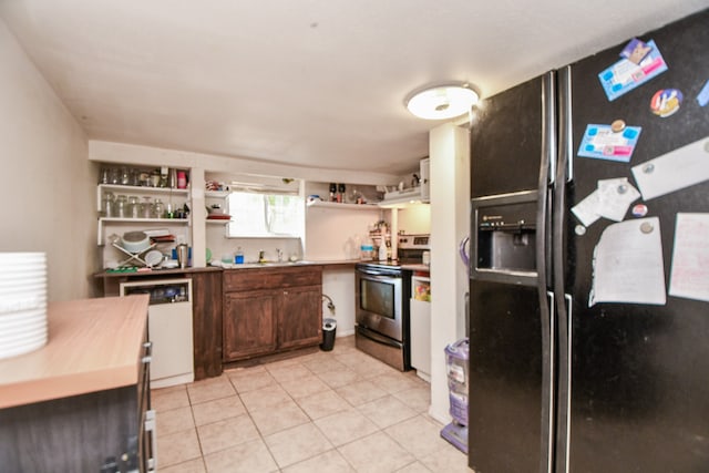 kitchen featuring light tile patterned floors, dishwasher, stainless steel electric stove, sink, and black refrigerator with ice dispenser