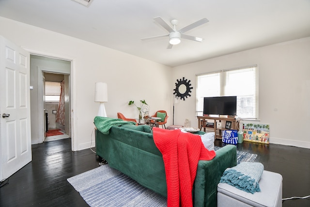 living room with ceiling fan and dark hardwood / wood-style floors