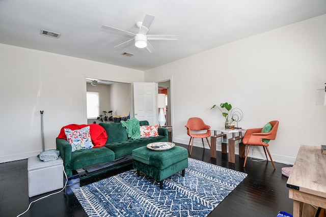 living room featuring ceiling fan and dark hardwood / wood-style flooring