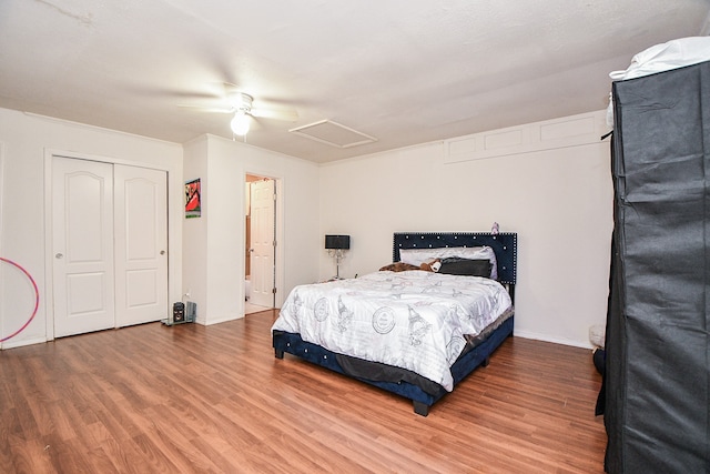 bedroom with ceiling fan, a closet, and wood-type flooring