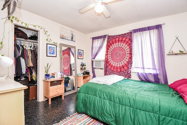 bedroom featuring multiple windows, ceiling fan, and a closet