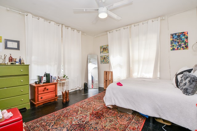 bedroom with ceiling fan and dark hardwood / wood-style flooring