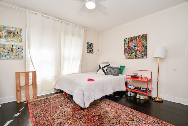 bedroom with ceiling fan and dark hardwood / wood-style floors