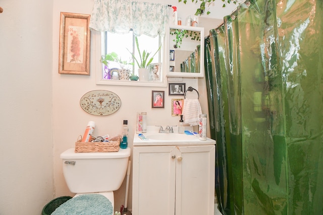 bathroom with vanity, toilet, and walk in shower