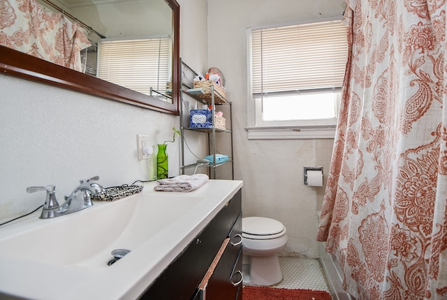 bathroom featuring tile patterned floors, walk in shower, toilet, and vanity