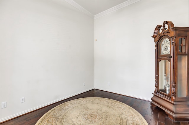 foyer entrance with ornamental molding and dark hardwood / wood-style floors