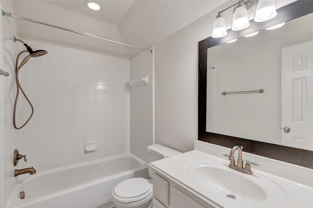 full bathroom with tiled shower / bath combo, vanity, and toilet