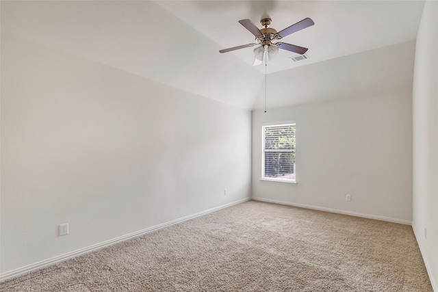 spare room featuring lofted ceiling, ceiling fan, and light carpet