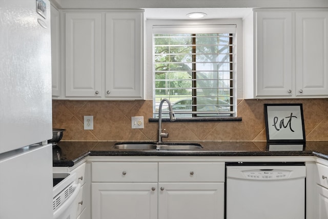 kitchen featuring white appliances, white cabinetry, sink, and tasteful backsplash