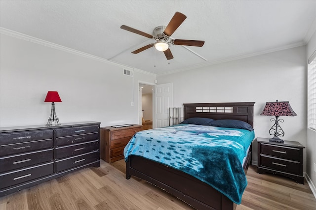 bedroom with light hardwood / wood-style floors, ceiling fan, and ornamental molding