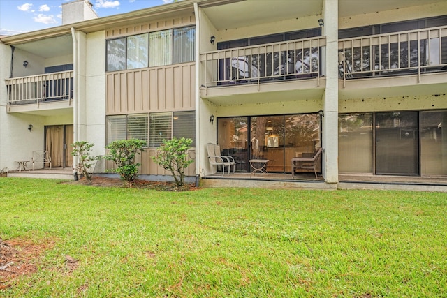 rear view of house with a yard