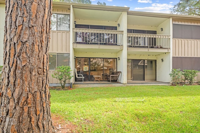 rear view of property featuring a yard