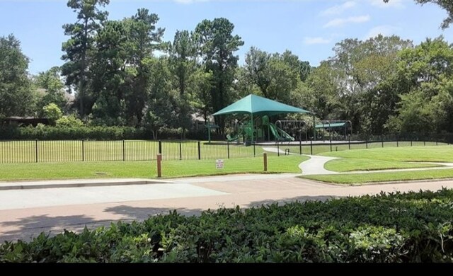 view of home's community with a playground and a lawn