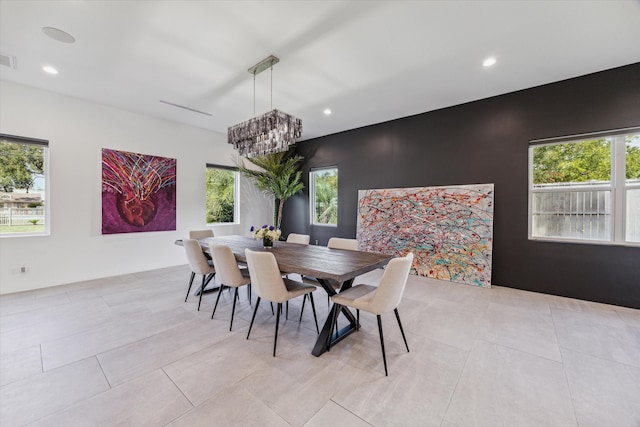 dining space with plenty of natural light and an inviting chandelier