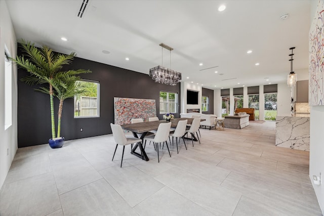 dining area featuring a notable chandelier and a healthy amount of sunlight