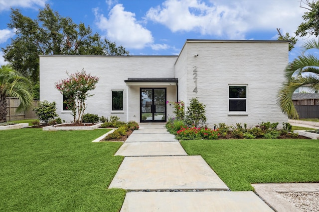 view of front facade featuring french doors and a front yard