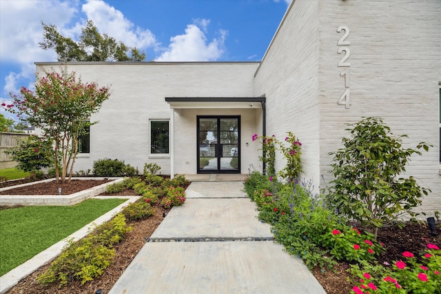 view of exterior entry featuring french doors