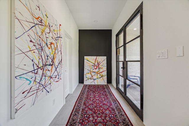 entryway with light tile patterned flooring