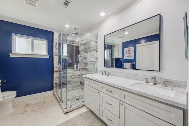 bathroom with crown molding, vanity, toilet, and a shower with door