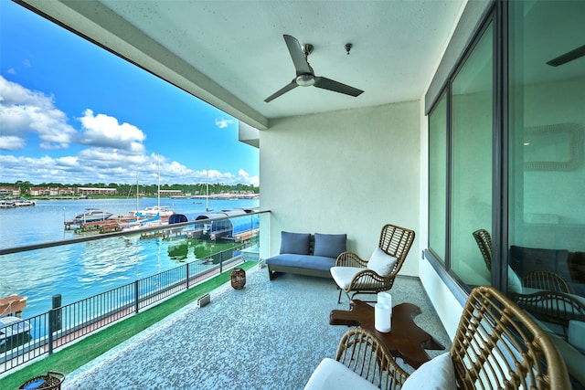 balcony with an outdoor hangout area, a water view, and ceiling fan