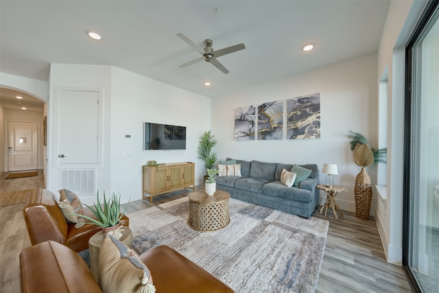 living room featuring ceiling fan and light hardwood / wood-style flooring