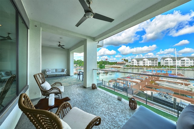 balcony with an outdoor hangout area, a water view, and ceiling fan