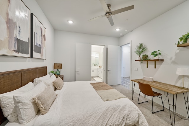 bedroom featuring light colored carpet, connected bathroom, and ceiling fan