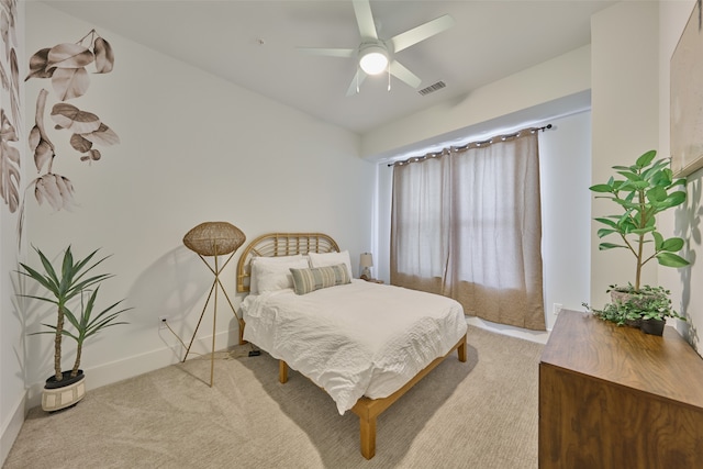 bedroom with light carpet and ceiling fan